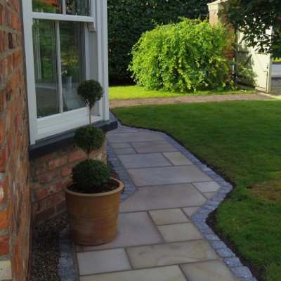 Linear paving with silver granite blocks running through