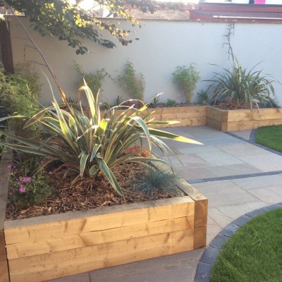 78. Sherburn-in-Elmet (after) Indian Stone with Charcoal Blocks, Wooden Raised Sleeper Planters and Planting 