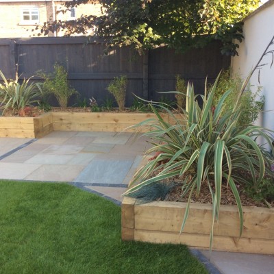 79. Sherburn-in-Elmet (after) Indian Stone with Charcoal Blocks, Wooden Raised Sleeper Planters and Planting