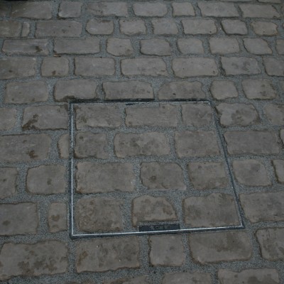 New lawn and design and Drivesys original cobble front driveway with discrete manhole cover